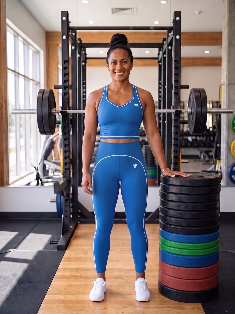 Talea in the YFYF Outline Set in Coastal Blue: racerback crop top and high-rise leggings with white piping, front