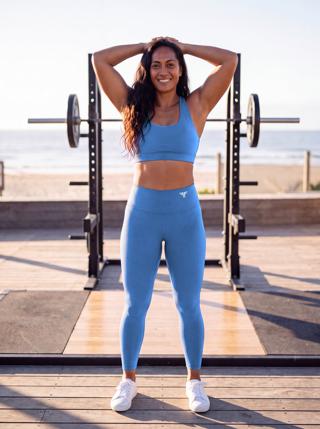 Talea wearing Coastal Blue Full Brand high-waisted leggings, front view with white FF logo