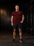 Clarke in the YFYF Jujube Red Heavyweight Cotton Tee, front, gold FF chest logo, in the gym