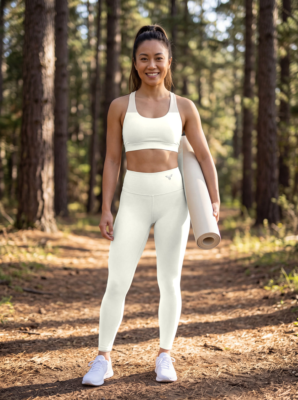 Kira wearing Beige Full Brand high-waisted leggings, front view with FF logo