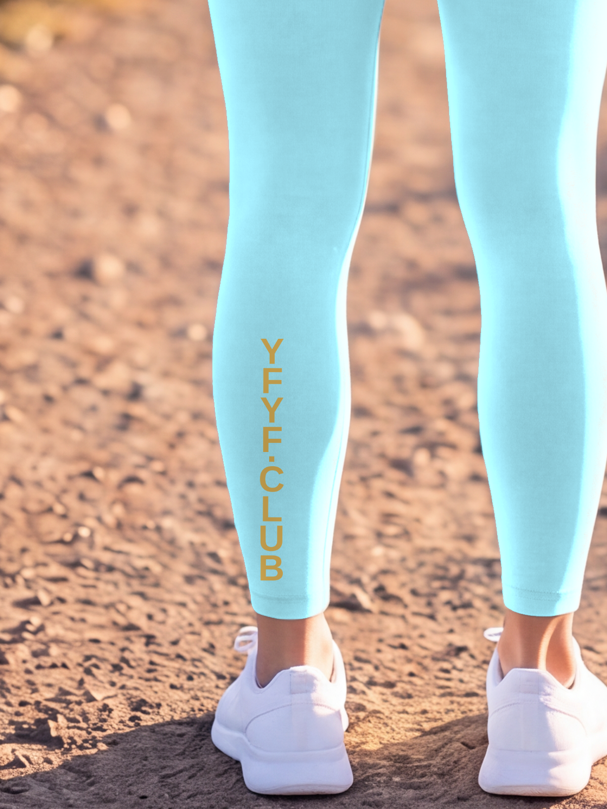 Close-up of the gold YFYF.CLUB print on the calf of the Lake Blue Full Brand leggings