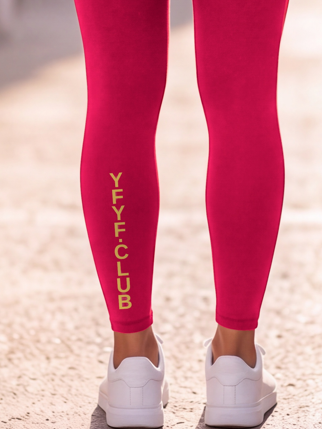 Close-up of the gold YFYF.CLUB print on the calf of the Cherry Full Brand leggings