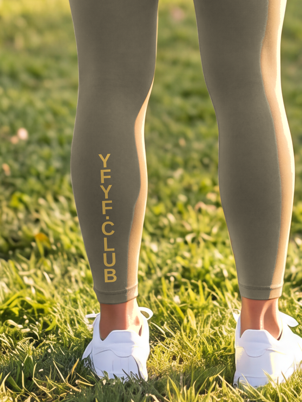 Close-up of the gold YFYF.CLUB print on the calf of the Olive Full Brand leggings