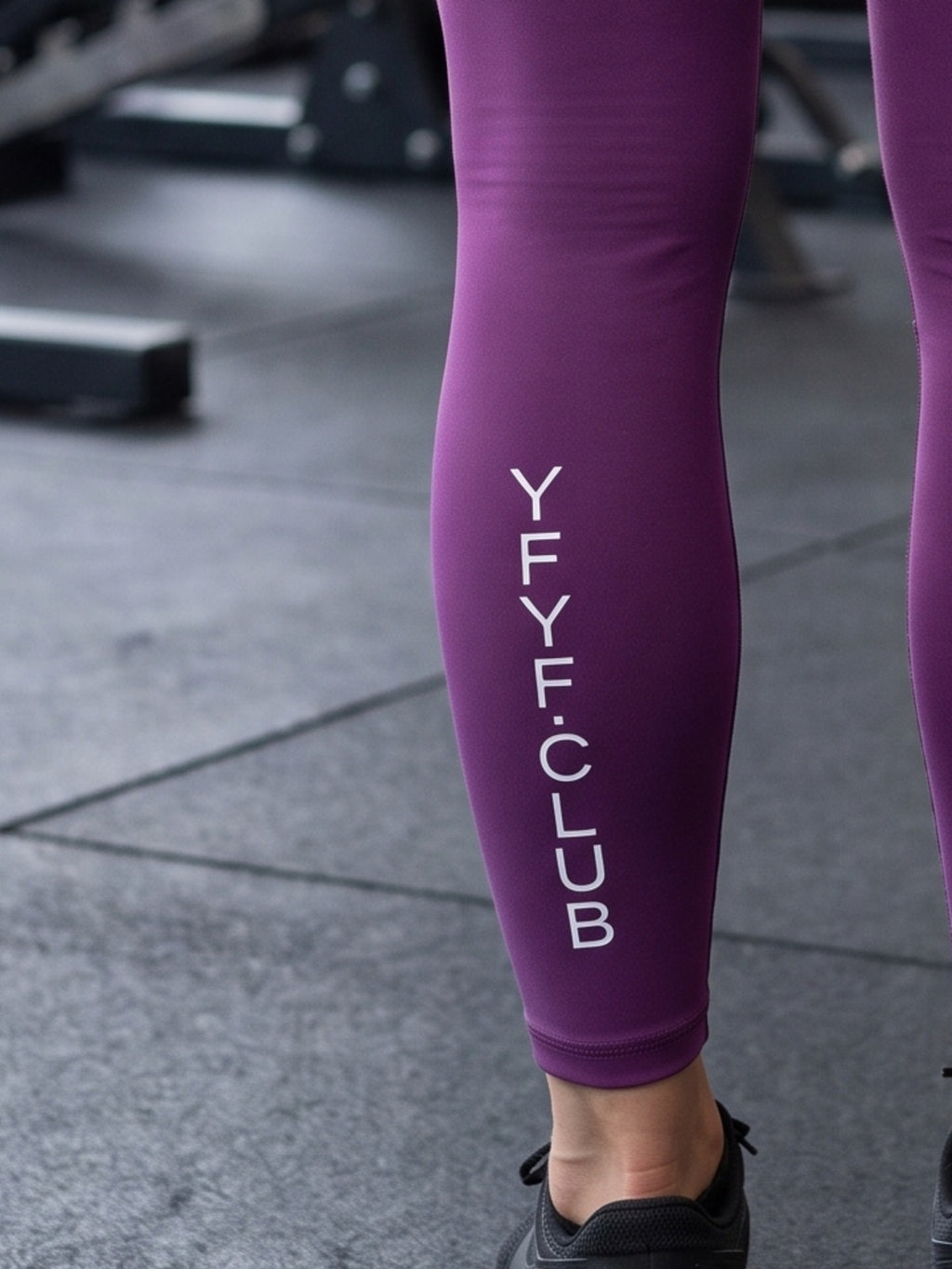 Close-up of YFYF.CLUB printed on the calf of the Purple White Logo leggings