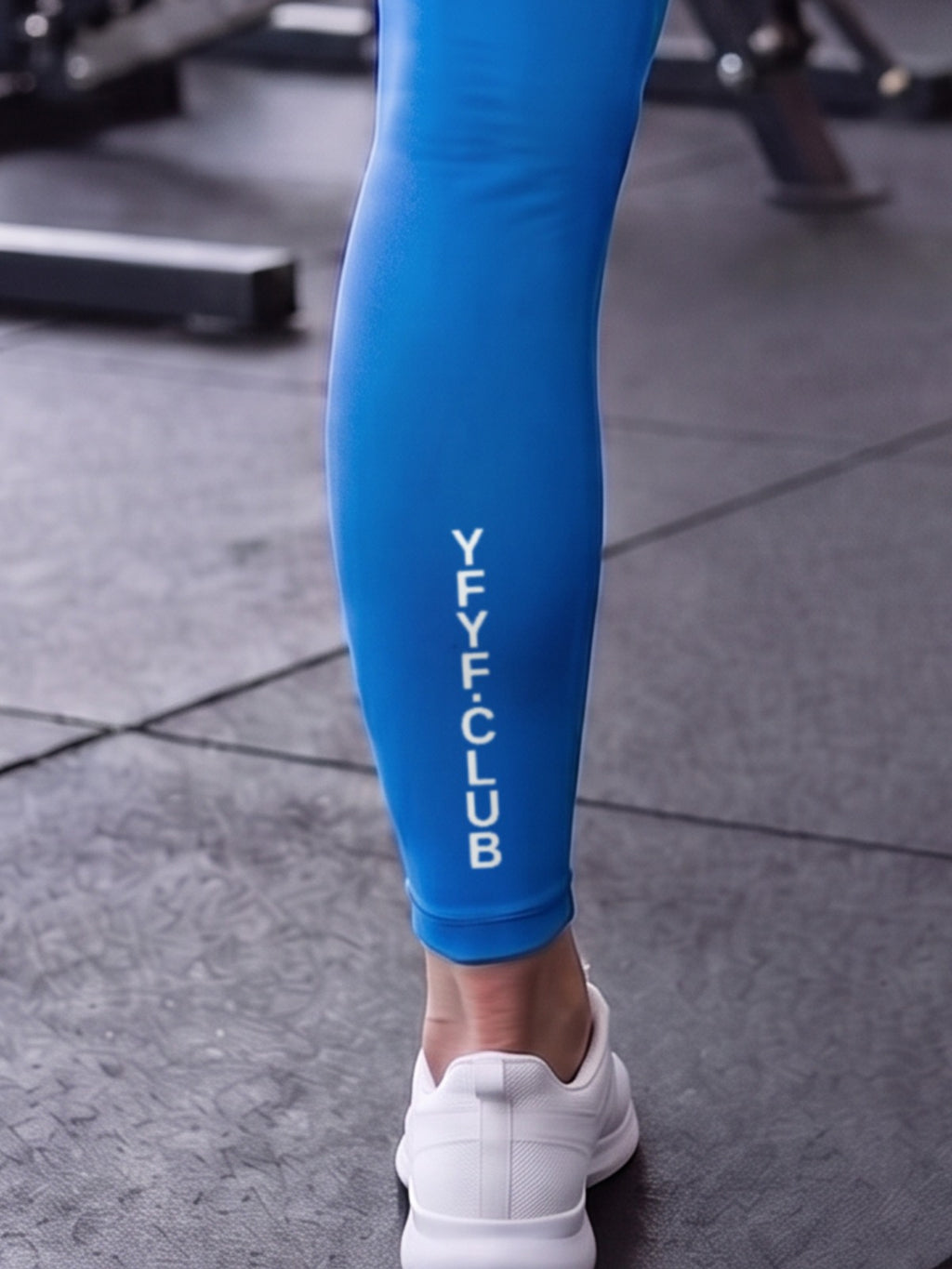 Close-up of YFYF.CLUB printed on the calf of the Coastal Blue White Logo leggings