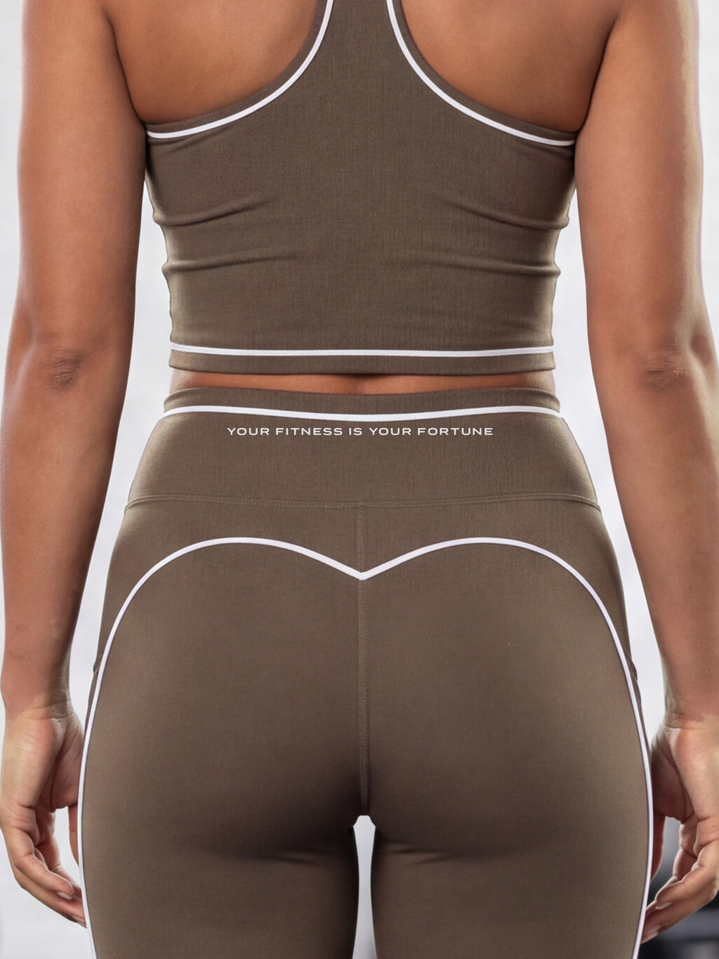 Close-up of the YFYF Outline Set in Coffee: crop top hem and leggings waistband with white piping