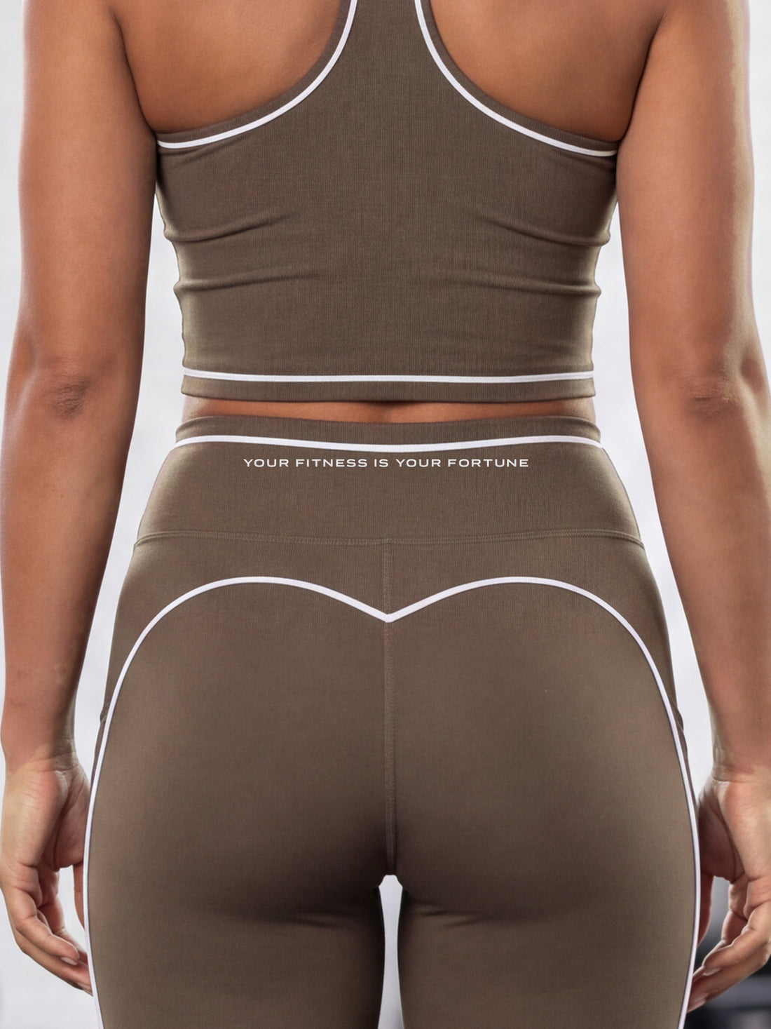 Close-up of the YFYF Outline Set in Coffee: crop top hem and leggings waistband with white piping
