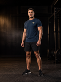 Clarke in the YFYF Navy Blue Heavyweight Cotton Tee, front, gold FF chest logo, in the gym