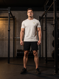 Clarke in the YFYF Oat Gray Heavyweight Cotton Tee, front, gold FF chest logo, in the gym