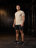 Clarke in the YFYF Pale Khaki Heavyweight Cotton Tee, front, gold FF chest logo, in the gym