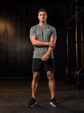 Clarke in the YFYF Heather Gray Heavyweight Cotton Tee, front, gold FF chest logo, in the gym