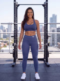 Elkie wearing the LTD Edition My Fitness Is Your Fortune leggings in royal blue, front view