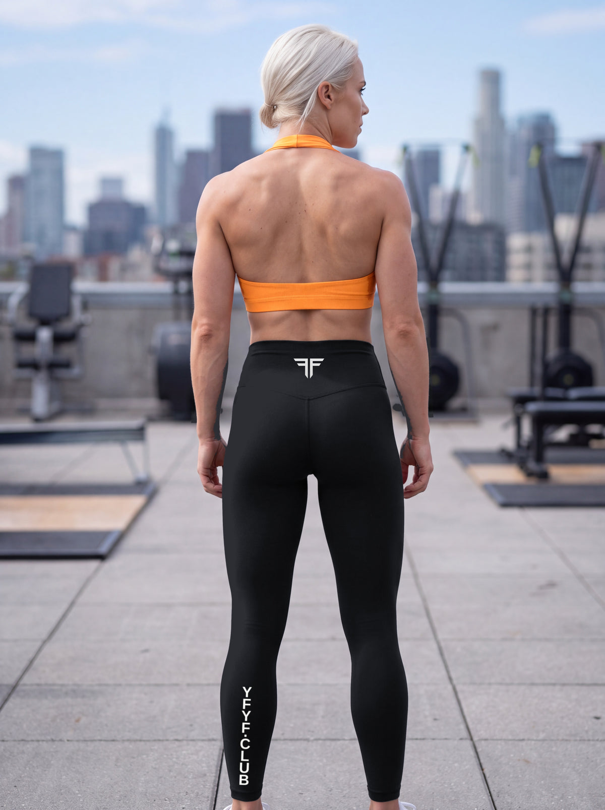 Katya wearing the YFYF Orange Pleated Halter Sports Bra, back view showing the halter neck and open back