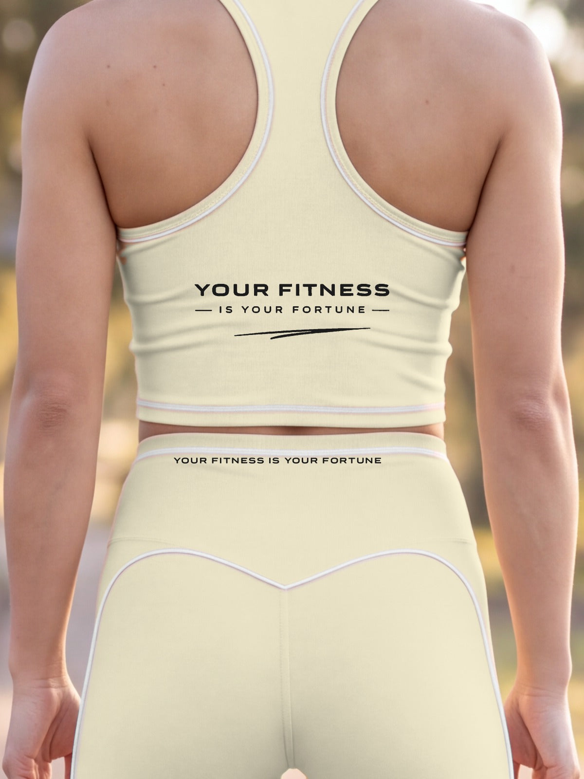 Close-up of the Your Fitness Is Your Fortune, with a signature stroke back print on the YFYF Fortune Signature Racerback Crop Top – Light Apricot