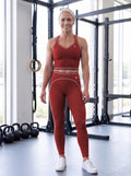 Katya in YFYF Fortune Signature Racerback Crop Top – Red, front, worn with Outline leggings in Red (sold separately)